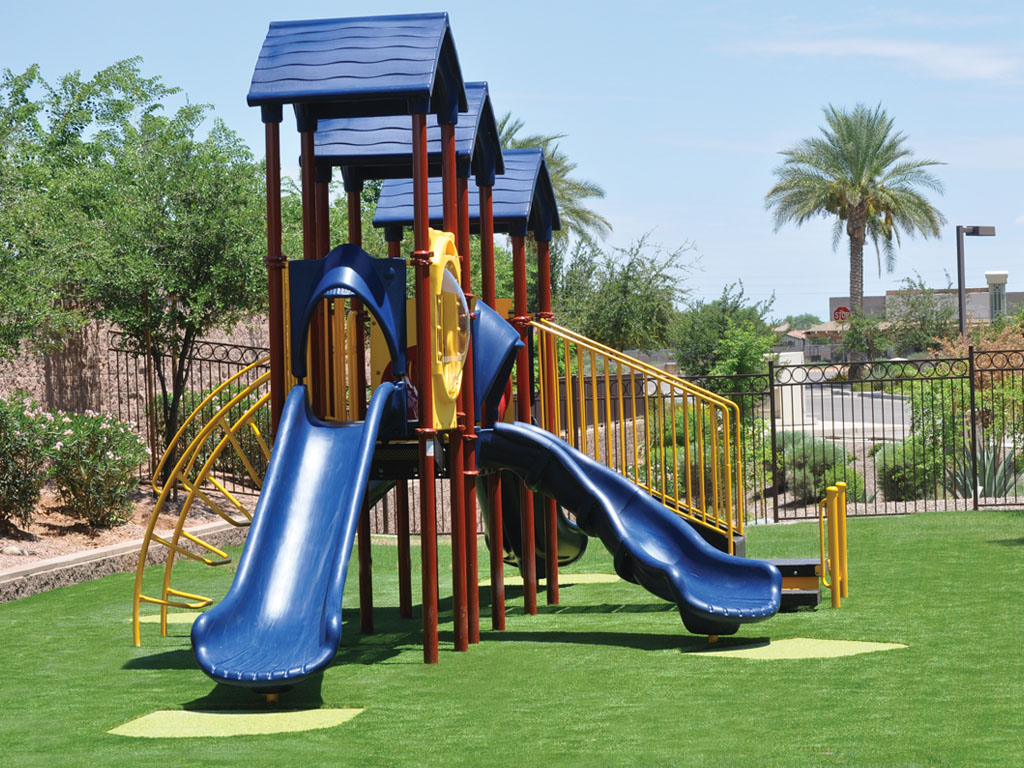 Playground Structure with Rubber patches at slide exits and Ameri-Grass protective safety surfacing